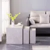 A living room scene with a sofa, nesting tables, and a vase of flowers. Podgląd zdjęcia produktu