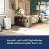 A bedroom with a portable air conditioner, a bed, a desk, and a bookshelf. Produktbild-Vorschau