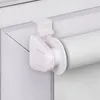 A close-up view of a white roller blind attached to a window frame without drilling. Produktbild-Vorschau