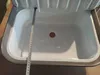 A white sink with a measuring tape inside. Náhled obrázku produktu