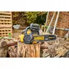 A yellow and black DeWalt chainsaw rests on a cut log in an outdoor setting with wooden pallets and a brick wall in the background. Voir les images du produit