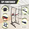A power tower fitness station is shown in a room with windows and some shelves in the background. Various features of the station are highlighted with callouts. Náhľad obrázku produktu