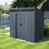A dark gray metal shed is shown in a grassy backyard with a fence and trees in the background. Produktbild-Vorschau