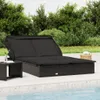A black rattan sun lounger with a canopy is placed on a patio next to a swimming pool. Náhľad obrázku produktu