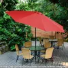 An outdoor patio scene with tables, chairs, and a large red umbrella. Voir les images du produit