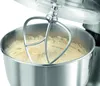 A close-up shot of a stand mixer with a beater attachment mixing a creamy batter in a stainless steel bowl. Produktbild-Vorschau