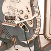 Close-up view of a wooden 3D puzzle in the shape of an electric guitar. Voir les images du produit