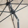 Close-up view of the internal mechanism and fabric of a beige umbrella. Produktbild-Vorschau