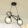 A black bicycle-shaped pendant light fixture hanging from a ceiling. Podgląd zdjęcia produktu