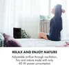 A woman is stretching in bed next to a black air cooler, with text overlay describing its features. Náhled obrázku produktu