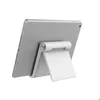 The back of a silver tablet is shown propped up by a white stand against a white background. Náhľad obrázku produktu