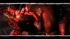 A violent scene from the video game God of War 3, showing Kratos fighting a large beast. Produktbild-Vorschau