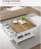 A coffee table with two open drawers, placed in a living room setting next to a sofa. Anteprima dell’immagine prodotto