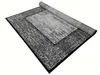 A rug is shown from a diagonal angle, partially rolled up. Náhled obrázku produktu