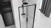 A modern bathroom with a black framed shower enclosure and marble-effect walls. Náhľad obrázku produktu