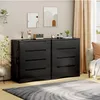 A modern bedroom or living room scene featuring two black dressers side-by-side, decorated with various items. Náhled obrázku produktu