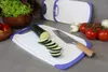 A kitchen scene with cutting boards, vegetables, and a knife. Anteprima dell’immagine prodotto