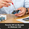A person is assembling a blue toy car with a screwdriver. A box with a picture of the car is visible. Náhľad obrázku produktu