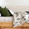 A close-up view of a bed with a duvet cover featuring a winter forest and deer pattern. Produktbild-Vorschau