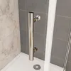 A close-up view of a shower enclosure with a chrome grab bar and tiled walls. Produktbild-Vorschau