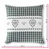 A square pillow with a green and white checkered pattern and a white band with embroidered hearts and decorative swirls. Produktbild-Vorschau