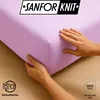 Hands holding a corner of a light purple fitted sheet, with a logo and certifications visible. Produktbild-Vorschau