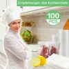 A chef in a kitchen setting, with vacuum seal bags and lemons in the foreground. Produktbild-Vorschau