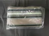 A striped awning fabric is folded and sealed in plastic packaging, lying on a gray surface. Produktbild-Vorschau