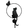 A black silhouette of a cat sitting inside a circular frame, with a butterfly on the top left. The frame has small lights around it and a solar panel at the bottom. Produktbild-Vorschau