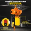 An orange electric chain hoist is suspended from a metal bar, with a yellow chain bag attached. A yellow control box with red and green buttons is shown in a close-up inset on the left, and a wired remote control is hanging from the hoist. Produktbild-Vorschau