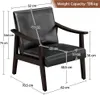 A black armchair with dimensions and weight capacity indicated by text and lines. Produktbild-Vorschau