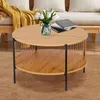 A round coffee table with a wooden top and a slatted base, placed on a brown rug in a living room setting. Produktbild-Vorschau