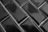 A close-up view of black mosaic tiles arranged in a herringbone pattern. Produktbild-Vorschau