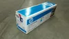 A product box for an HP toner cartridge placed on a concrete floor. Náhled obrázku produktu