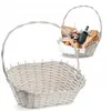 A white wicker basket with a handle is shown in the foreground, with another similar basket filled with food items in the background. Podgląd zdjęcia produktu