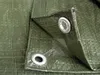 Close-up of a green tarp with metal grommets. Produktbild-Vorschau