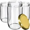 Three clear glass jars with one gold lid in the foreground. Náhled obrázku produktu