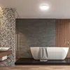 A modern bathroom with a freestanding bathtub, a tiled wall, and wooden accents. Náhľad obrázku produktu