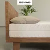 Close-up of a mattress on a wooden bed frame with a pillow and a plant. Produktbild-Vorschau
