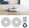 A robot vacuum cleaner on a wooden floor and two mop pads with icons. Produktbild-Vorschau