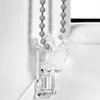 A close-up of a clear plastic bracket holding a beaded pull cord for a window blind. Produktbild-Vorschau