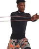 A man is shown exercising with resistance bands. Produktbild-Vorschau