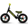 A black balance bike with yellow accents and colorful lights on the wheels, shown against a white background. Produktbild-Vorschau