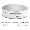 A white rotating display stand with a mirrored surface, showing control buttons and labels. Náhled obrázku produktu