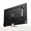 The back of a black LED TV is shown, mounted on a silver stand, against a white background. Produktbild-Vorschau