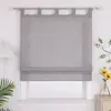 A gray Roman shade hangs on a window, with a lamp on the left and a vase of flowers on the right. Produktbild-Vorschau