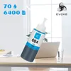 A bottle of cyan ink is placed on a desk in front of a laptop. Produktbild-Vorschau