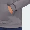 Close-up of a person's hand in the pocket of a gray hooded sweatshirt. Náhľad obrázku produktu