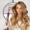 A woman is using an automatic hair curler to style her blonde hair. The curler is shown in action, wrapping a section of hair. Produktbild-Vorschau