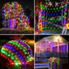 A collage of four images showcasing colorful LED string lights decorating outdoor spaces like trees, bushes, and a porch. Produktbild-Vorschau
